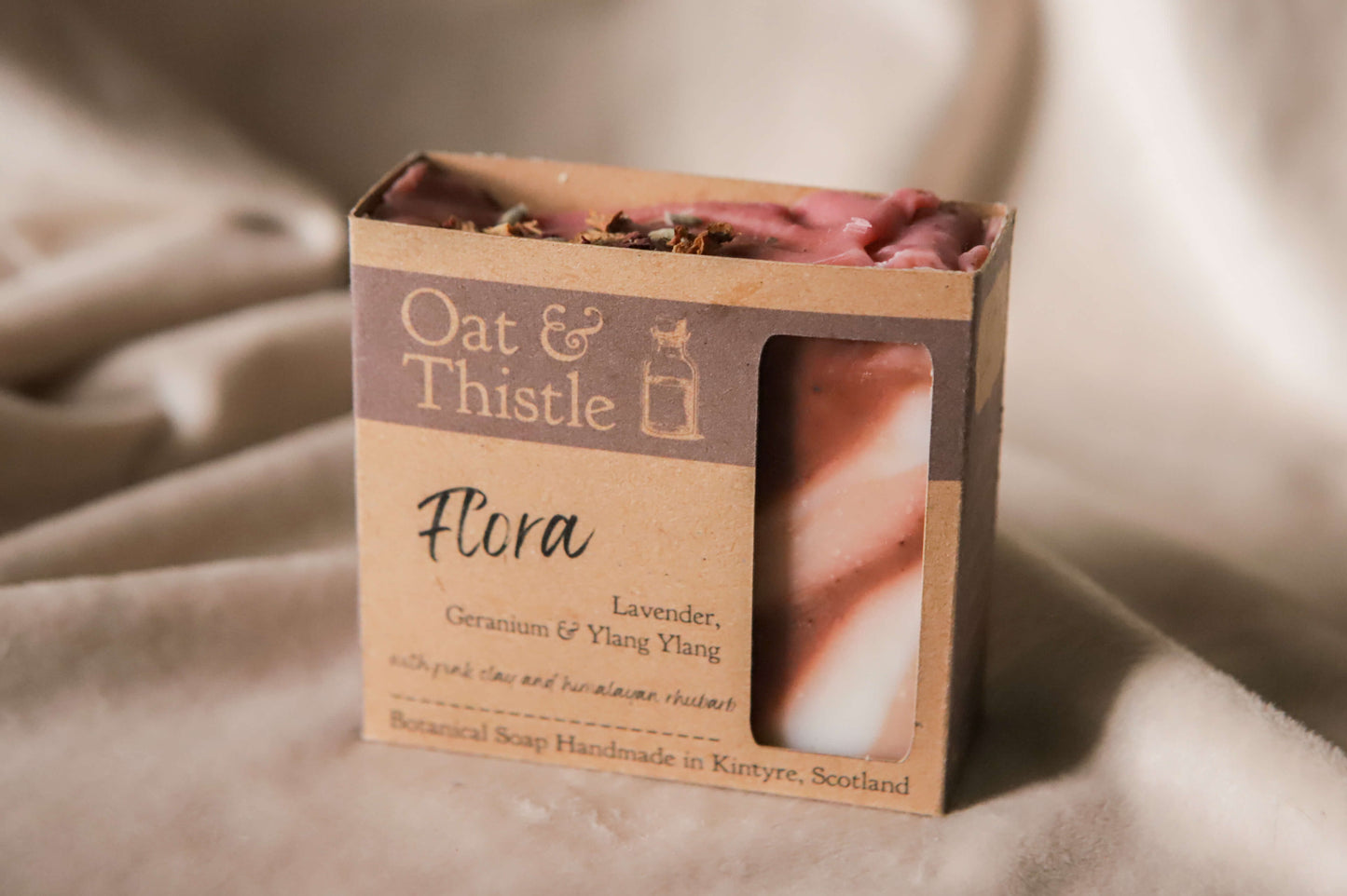 Flora soap bar in packaging box, red pink and white swirls