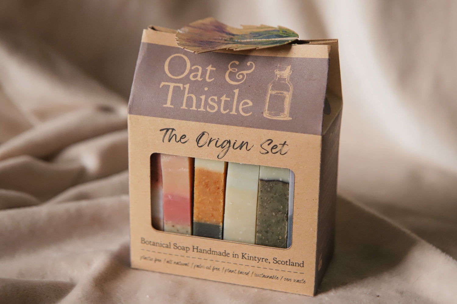 All 6 origin soaps in the origin set gift box— flora - red, pink/purple - heather, spice - orange, mentha - yellow, fern - green, moss - blue