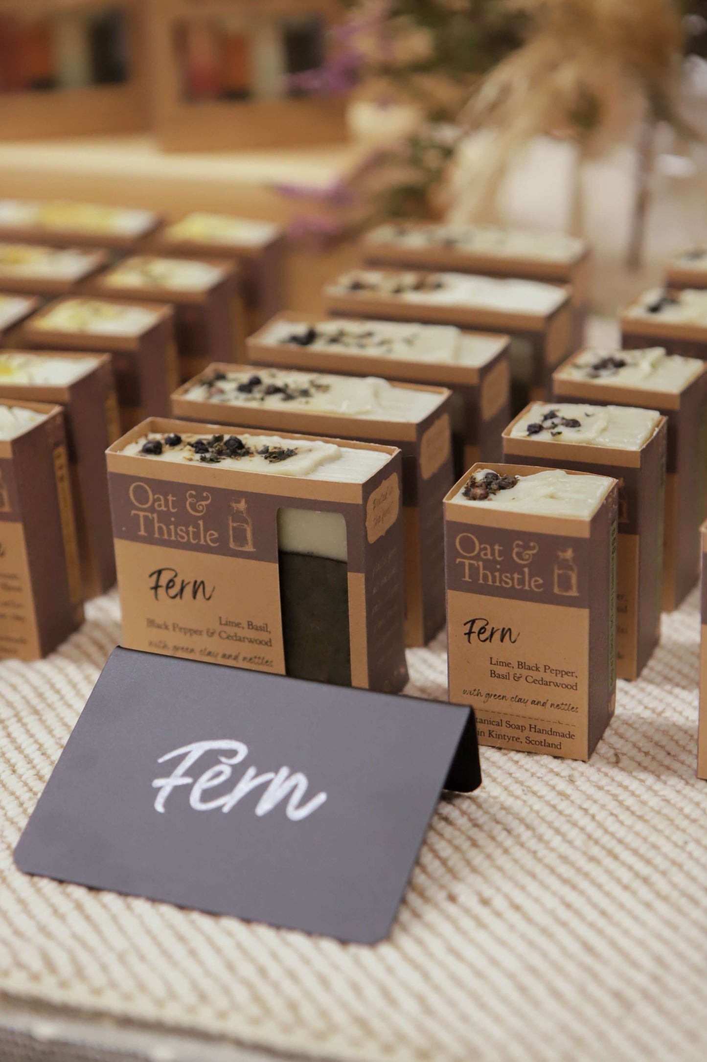 Fern soap bars in packaging on market table