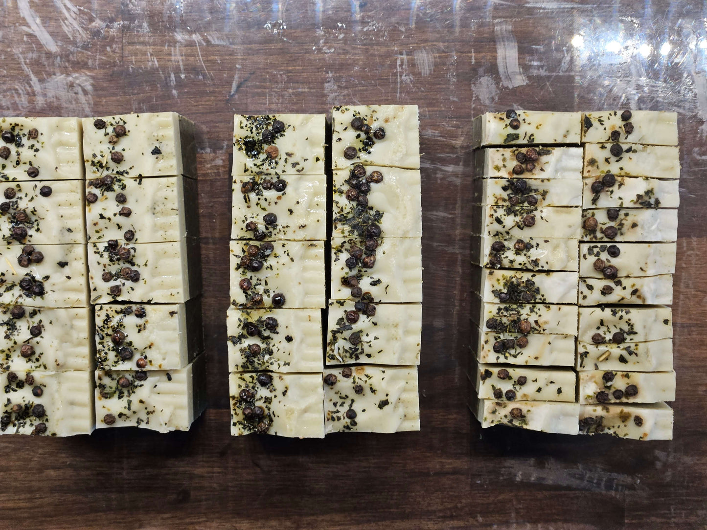 fern soap from above, peppercorns and nettles on light green soap colour