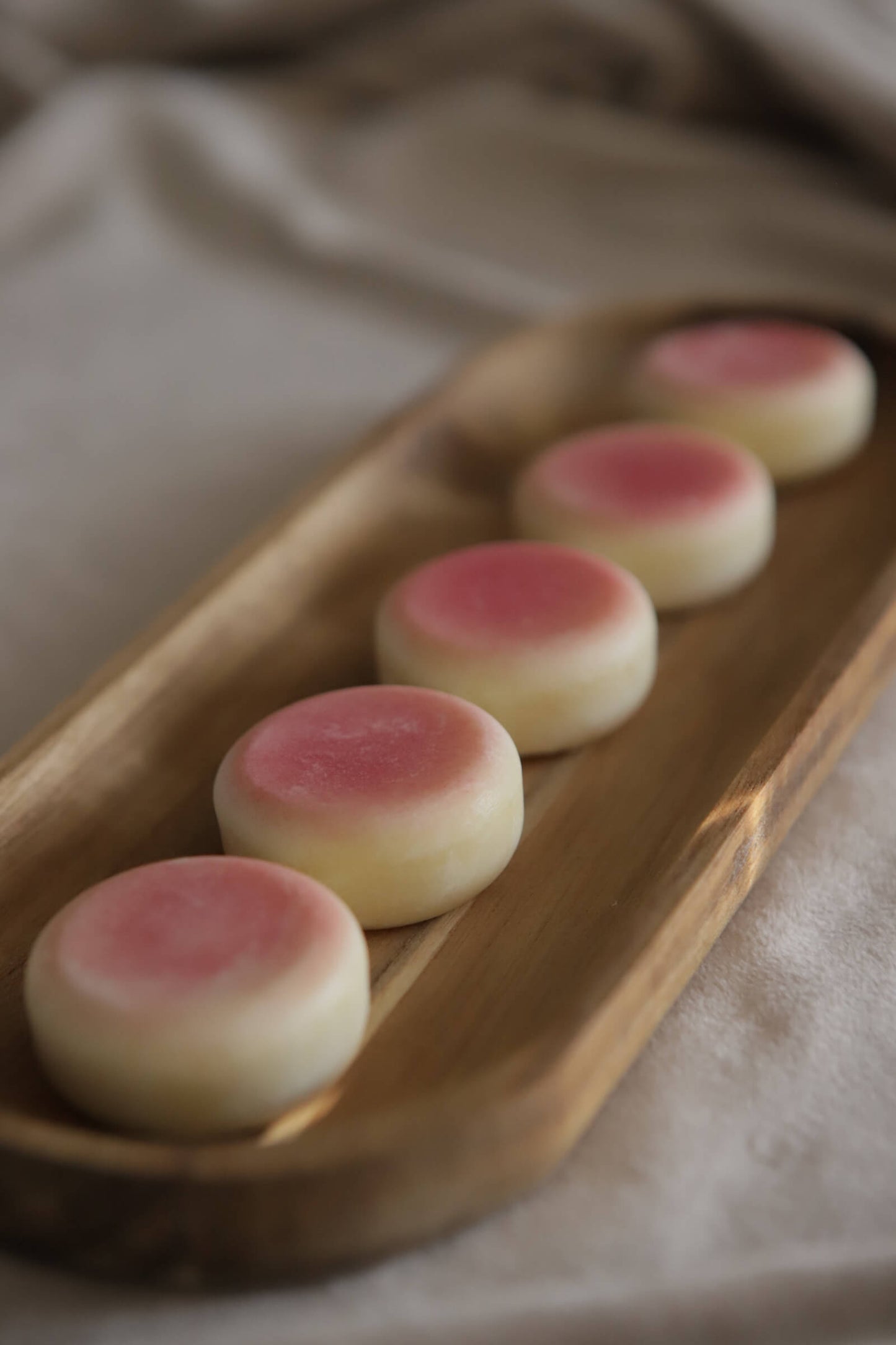 pink sol lotion bars on wooden tray