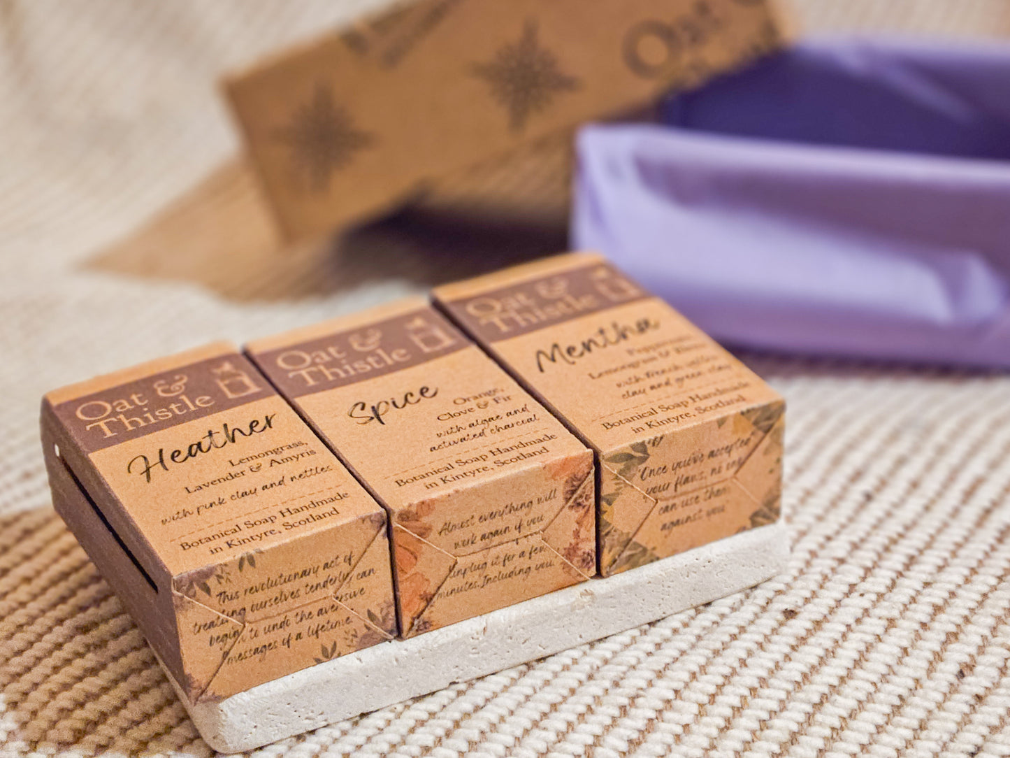 3 hald soap bars on a travertine soap dish