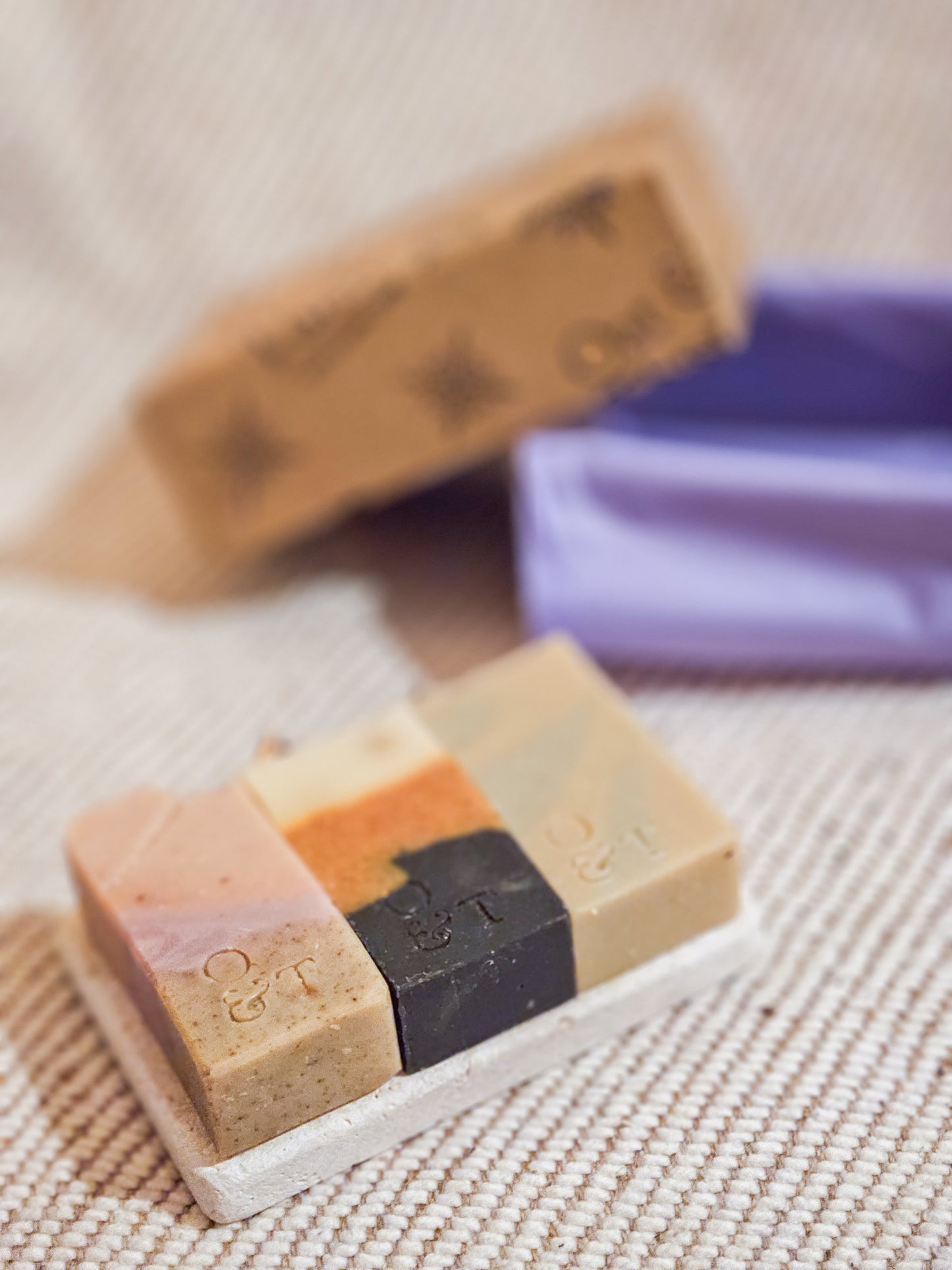 3 half soap bars on travertine soap dish