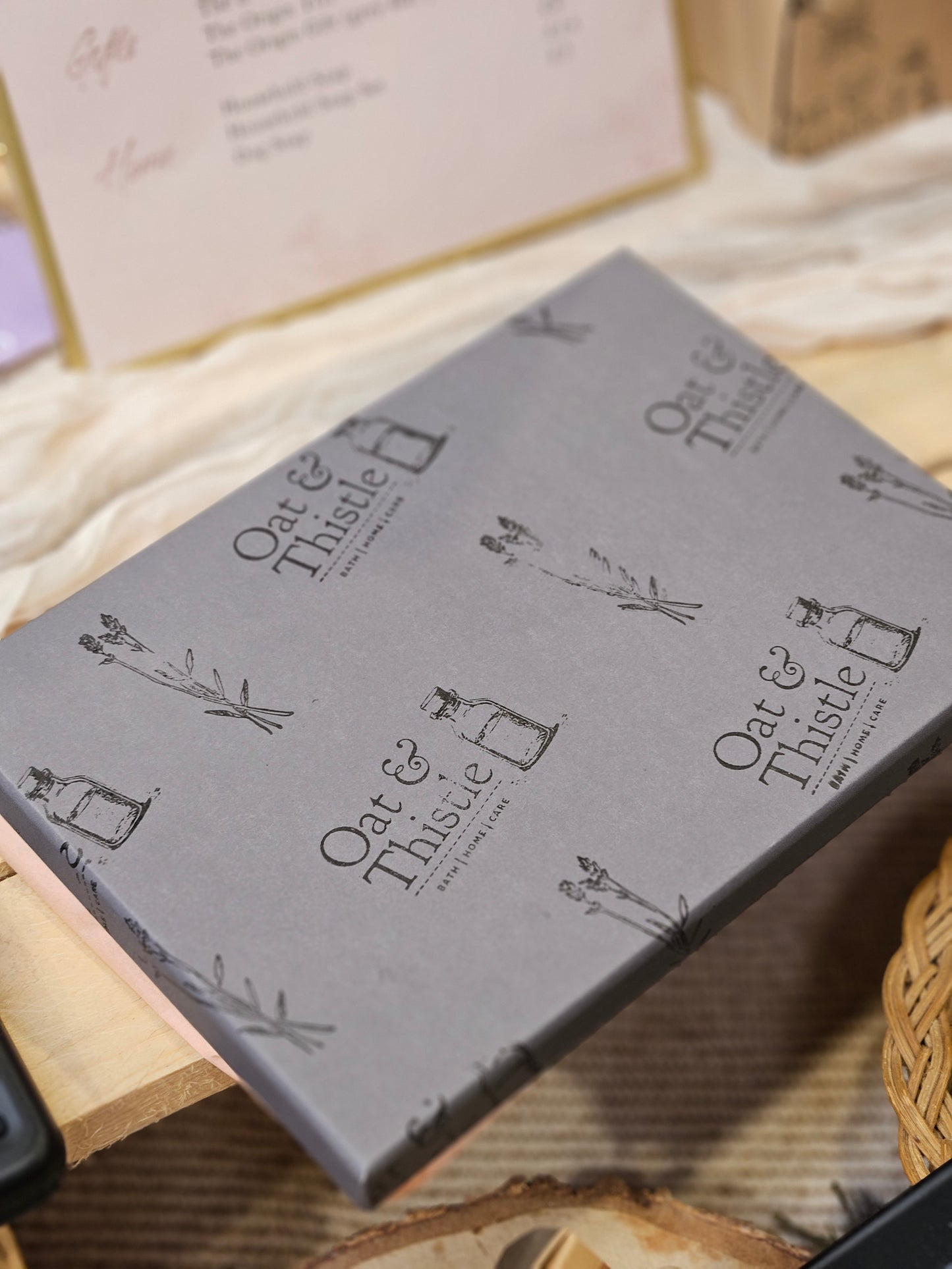 the origin gift box outer box, grey stamped in oat & thistle logo