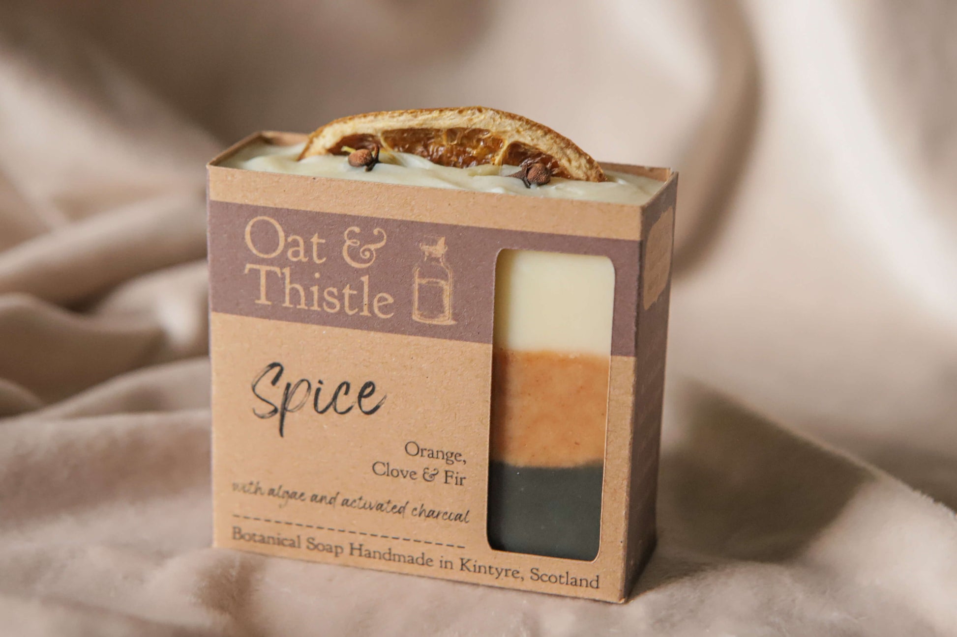 Spice soap bar in packaging, black orange and creamy white