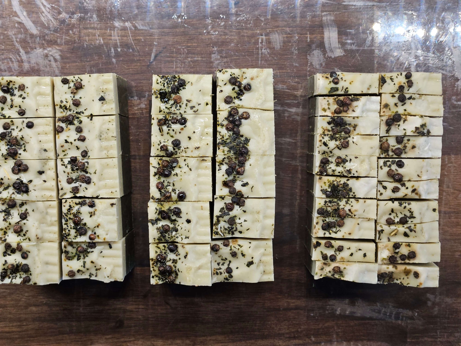 fern soap from above, peppercorns and nettles on light green soap colour