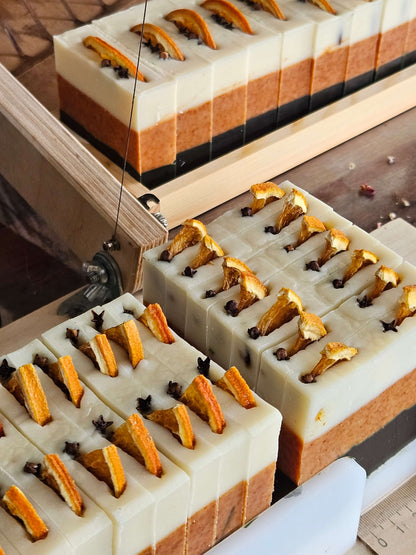 thin spice soap bars on the soap cutter ready to be cut into thin slices