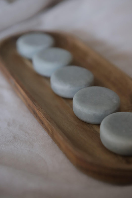 Blue heather lotion bars in a wooden tray