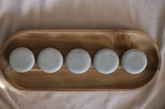 Blue heather lotion bars on wooden tray